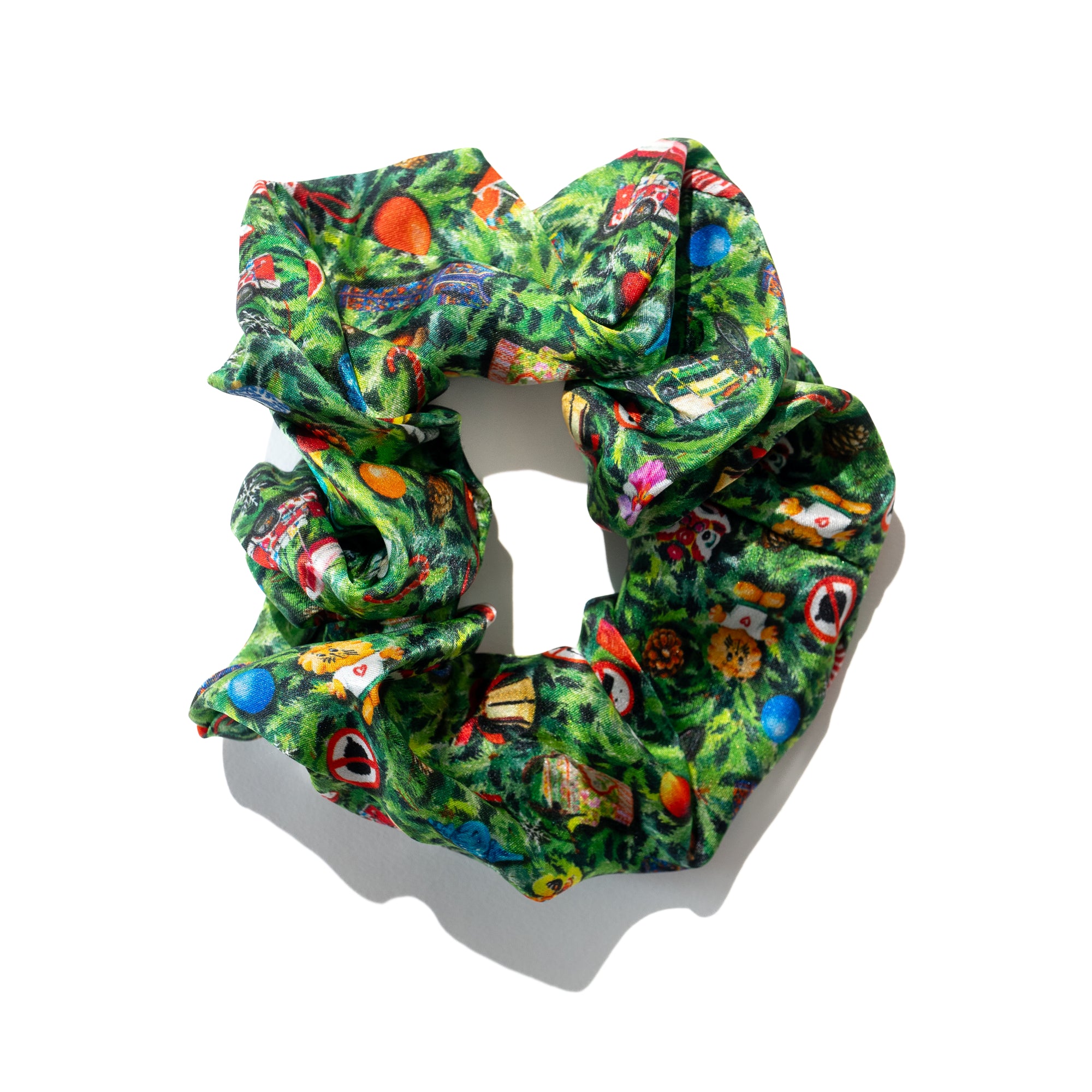 Singlapa multicolored silk scrunchie with a Christmas theme, featuring various holiday motifs intertwined with iconic Singaporean symbols.