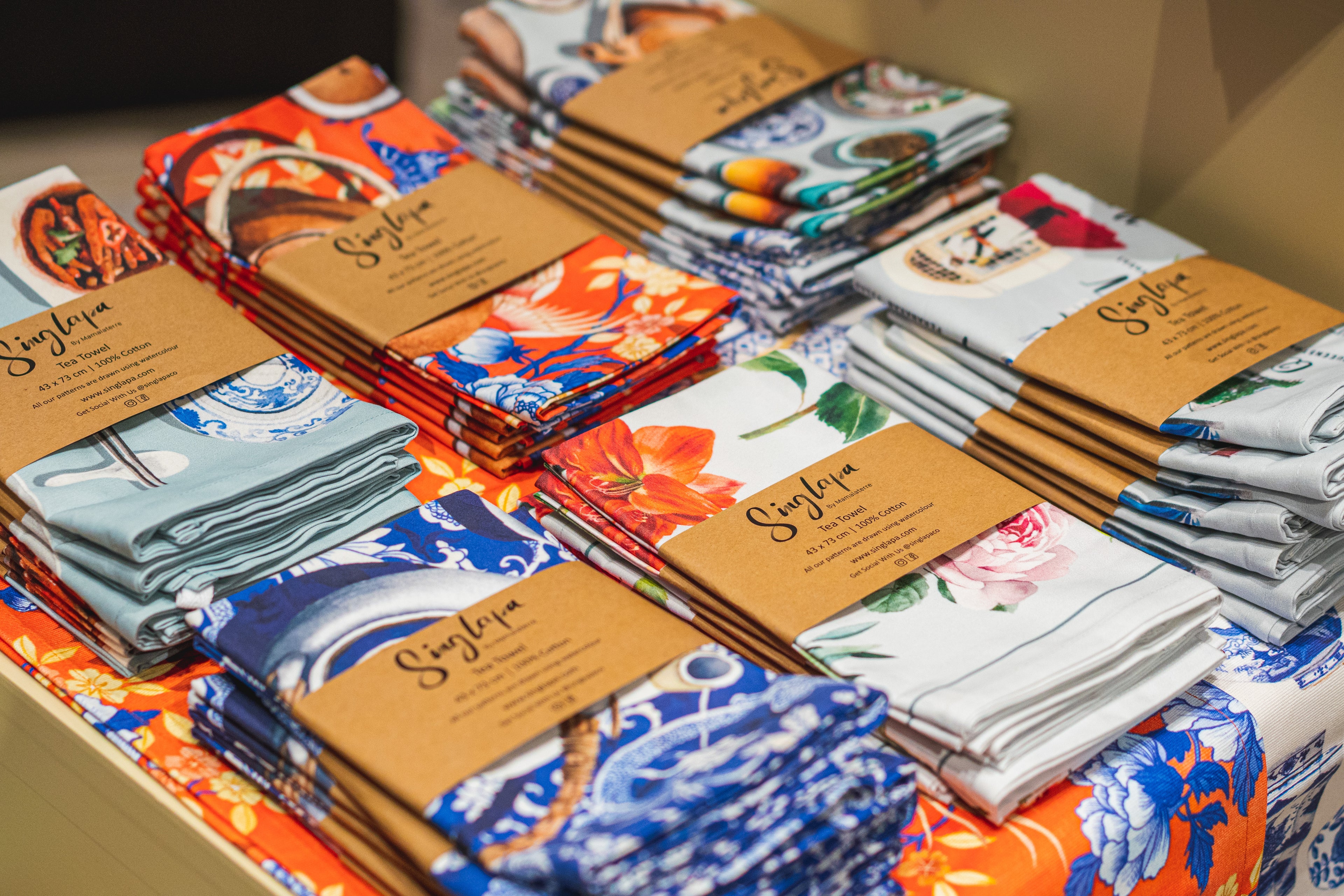 Singlapa tea towels on display shelves, crafted from sustainable materials and designed for everyday use