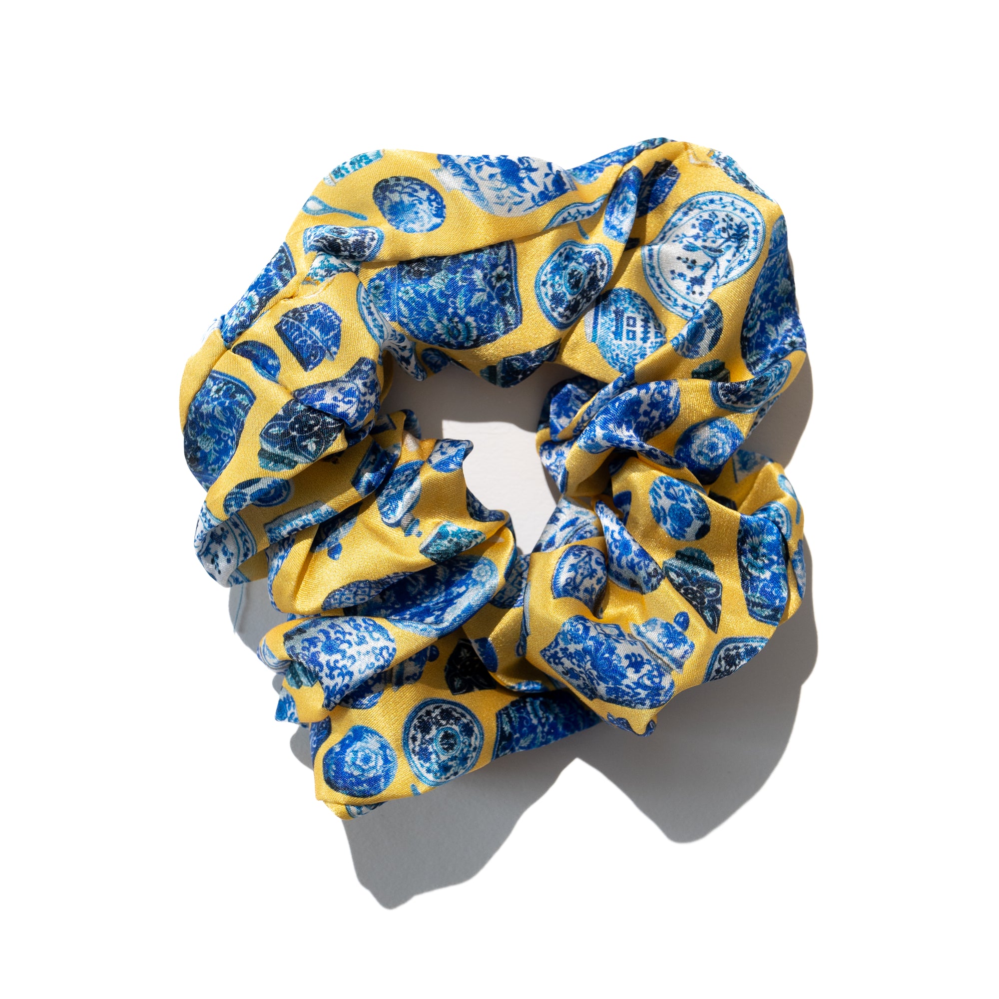 Singlapa yellow silk scrunchie with blue porcelain kitchenware design all over.