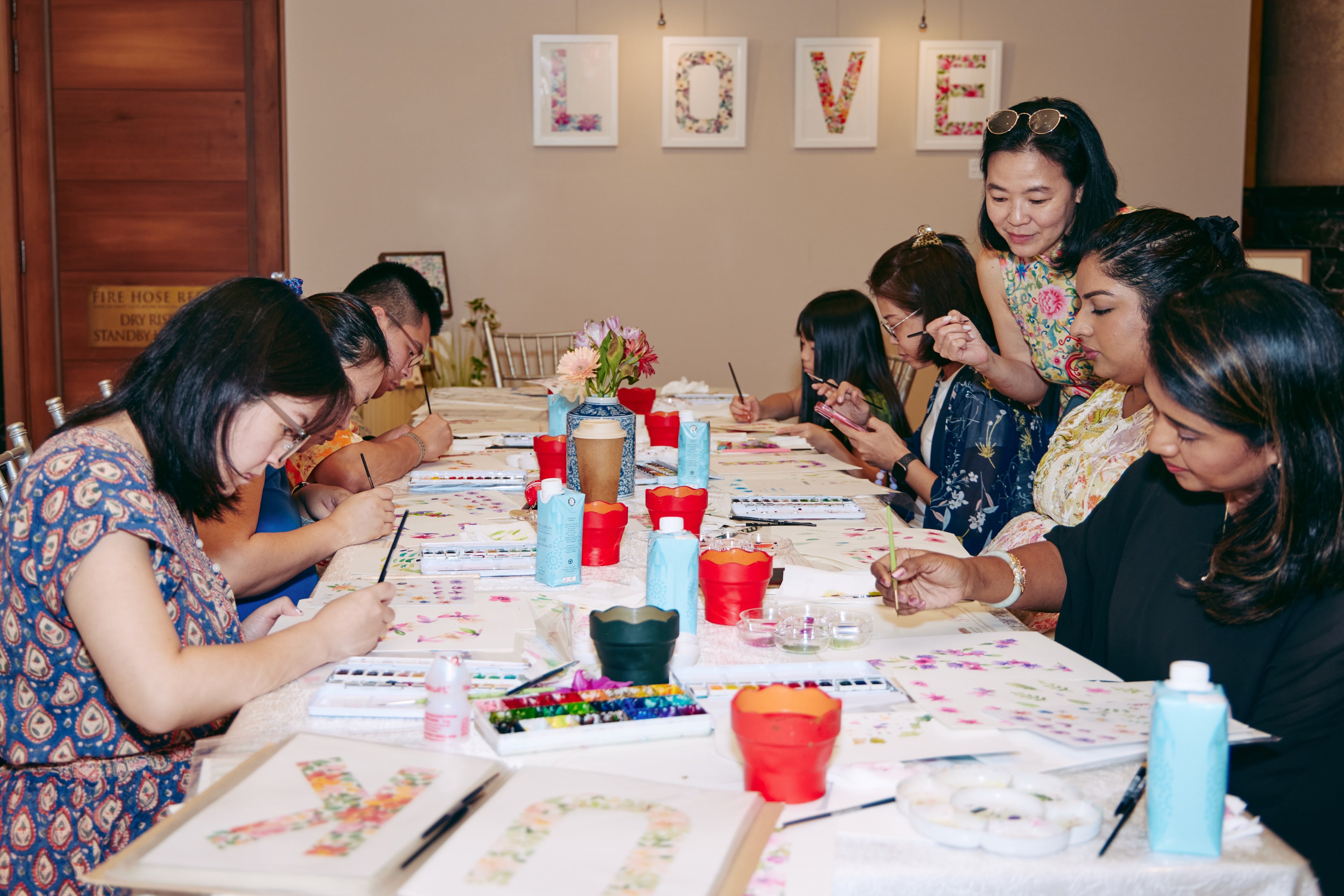 Singlapa watercolor workshop with participants painting while the instructor guides the class