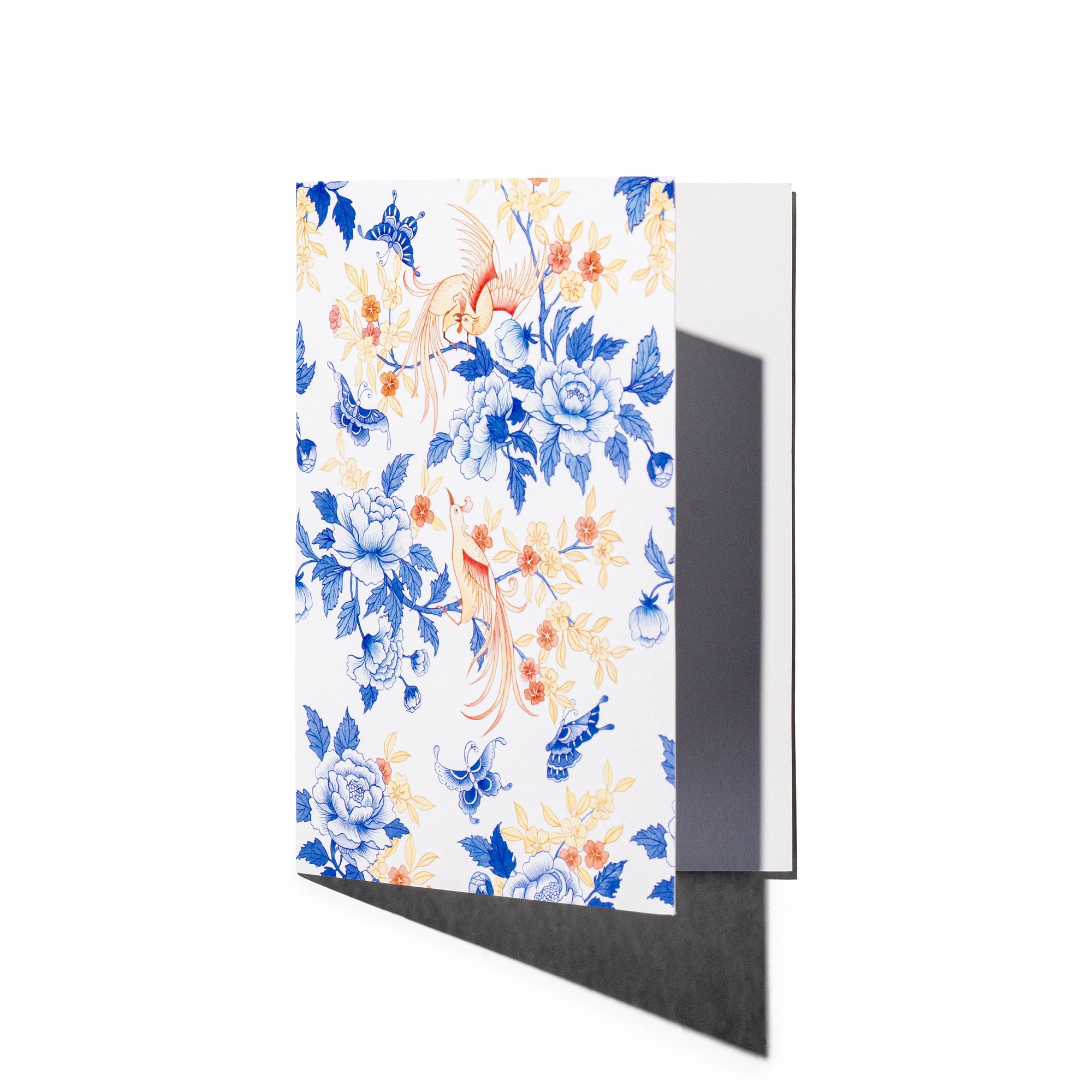Singlapa greeting card with a white frame featuring a watercolored floral pattern with birds and butterflies in shades of blue, orange, and white.