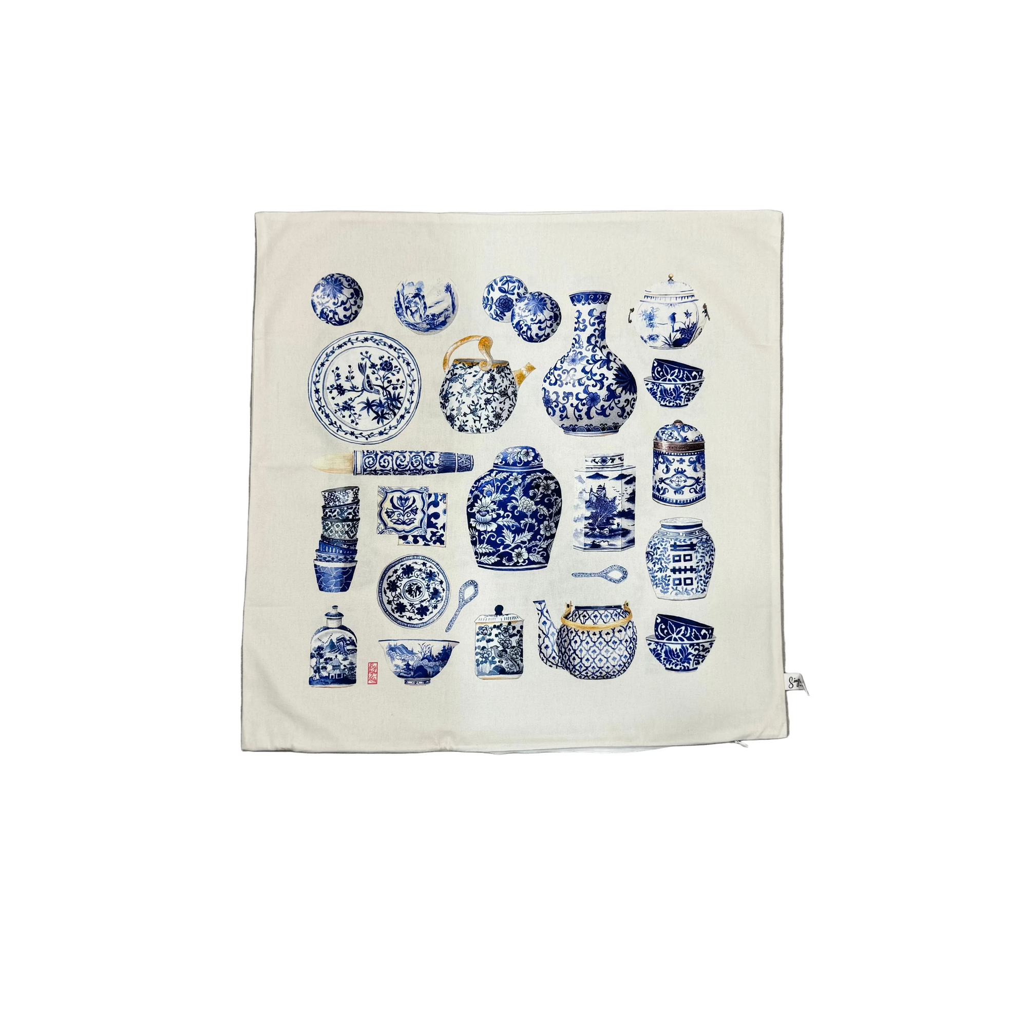 White cushion cover with blue and white ceramic design on a white background
