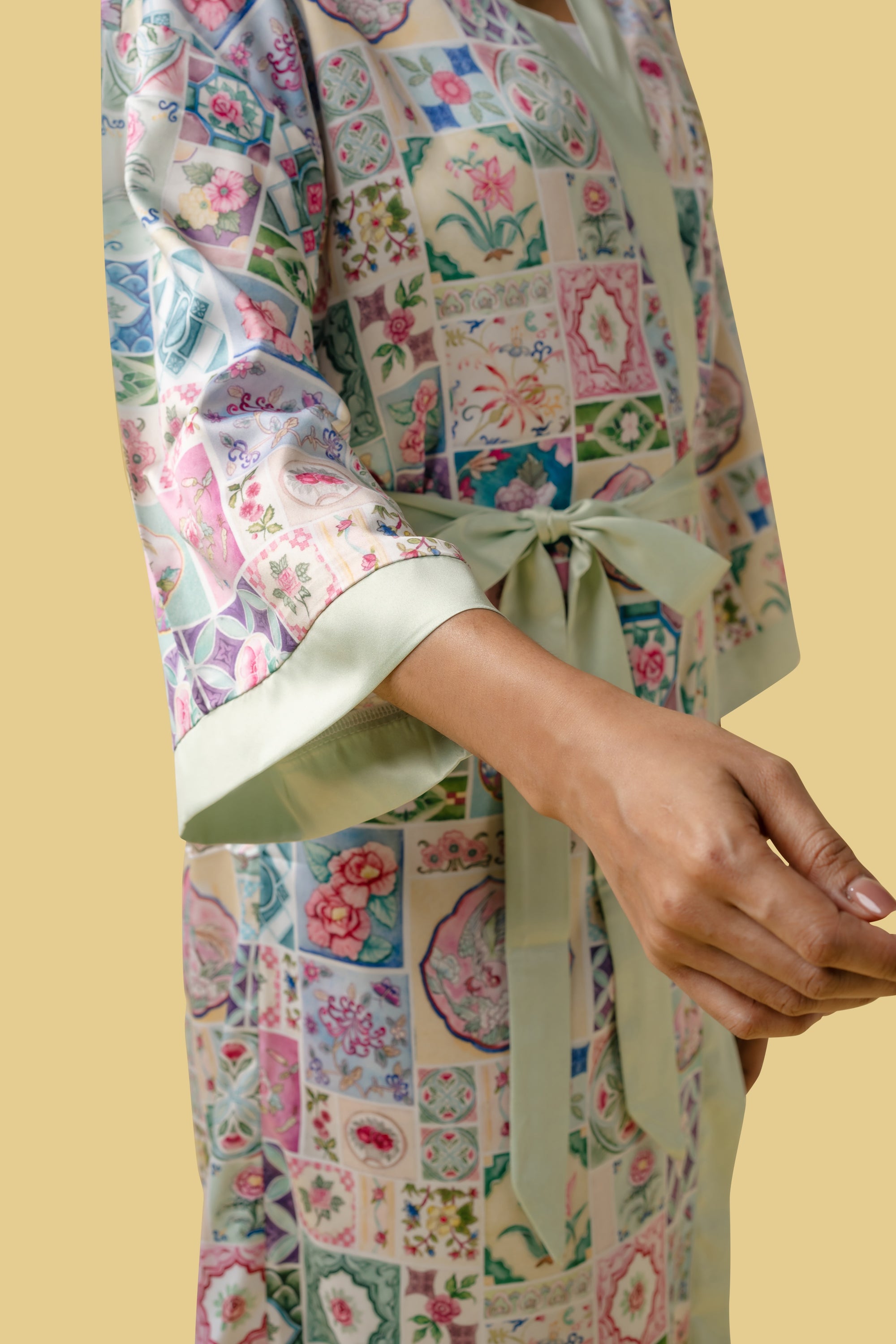 Closeup of a woman wearing the floral kimono from the side view.