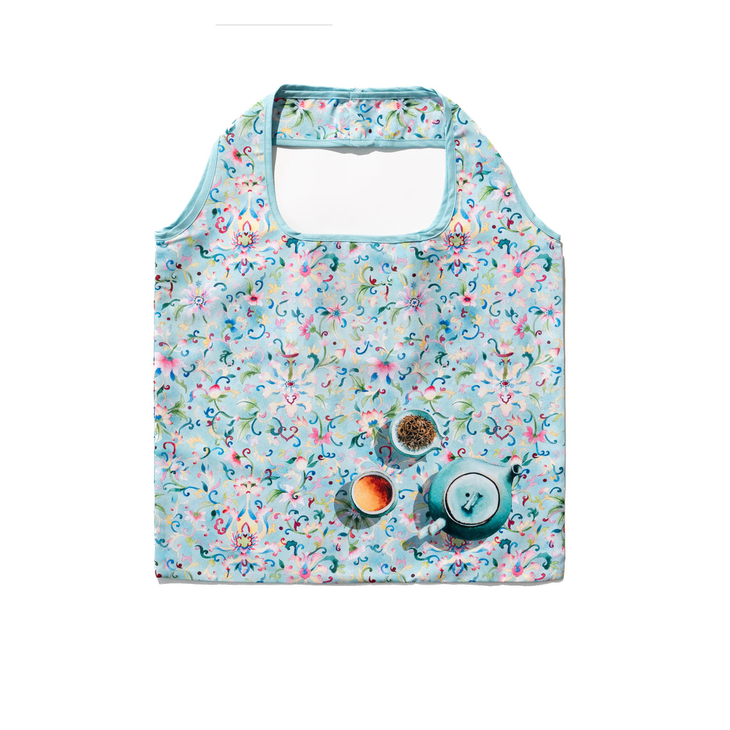 Singlapa multicolored floral shopping bag with a light blue background and handles.