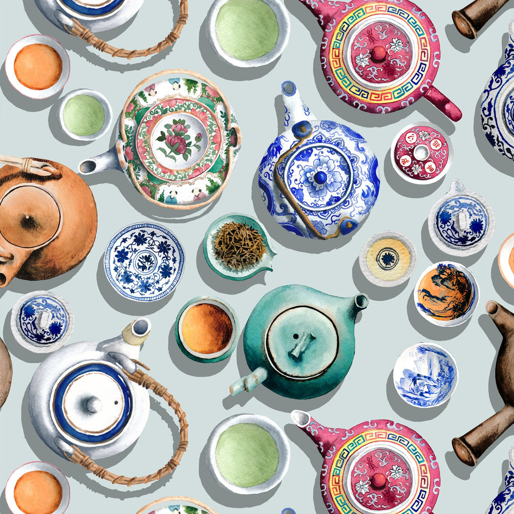 Chinese peranakan teapots and cups on a light blue background