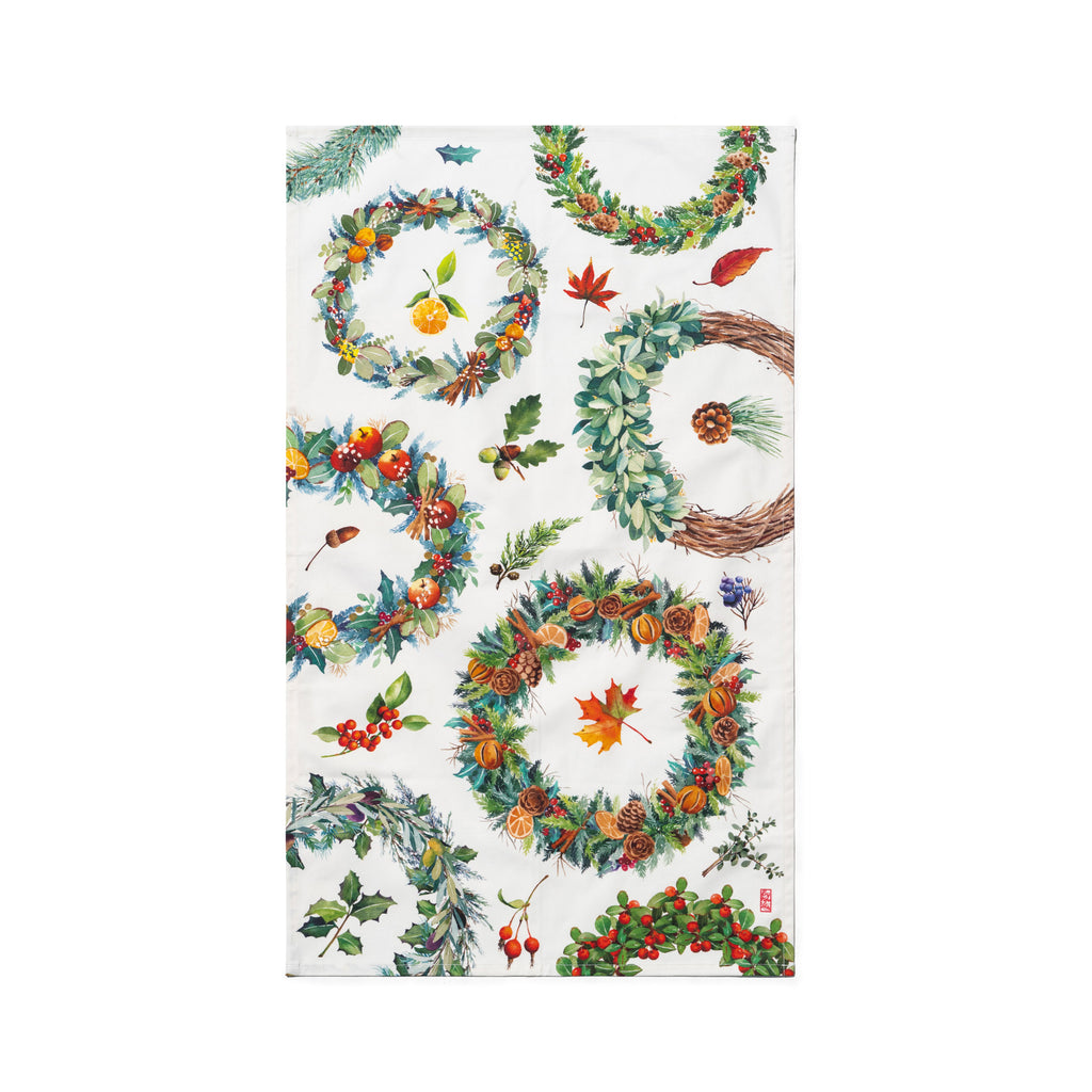 Singlapa tea towel with a Christmas wreath design featuring various circular patterns of greenery, berries, and decorative elements.
