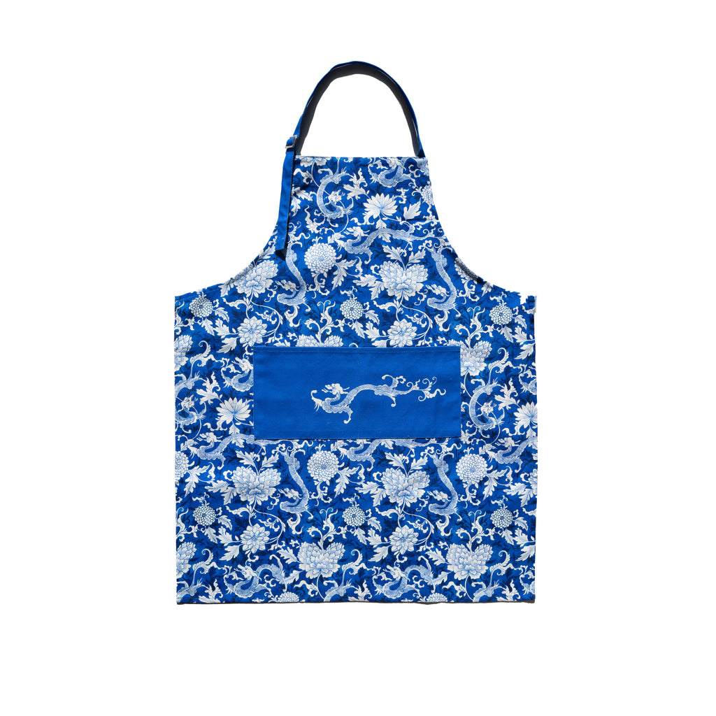 A blue apron with a floral and dragon pattern and a larger depiction of a dragon in the center.