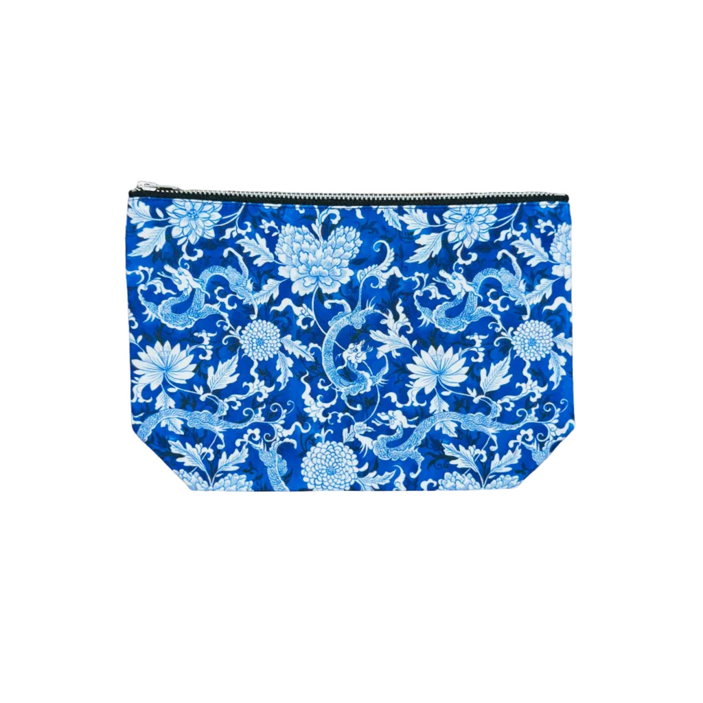 Blue pouch with white floral dragon 
pattern on a white background