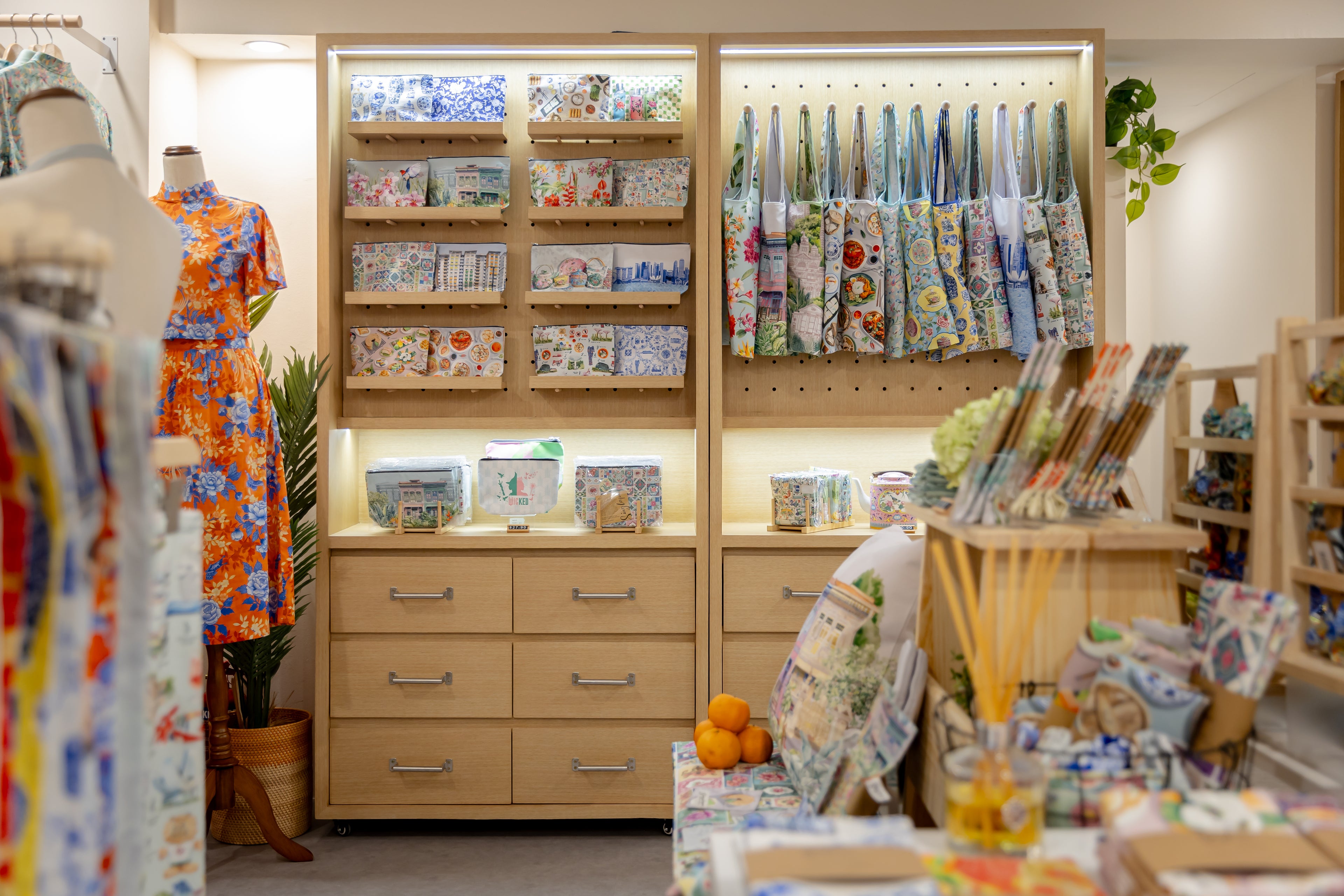 Store interior with shelves displaying various items and a table with more products.