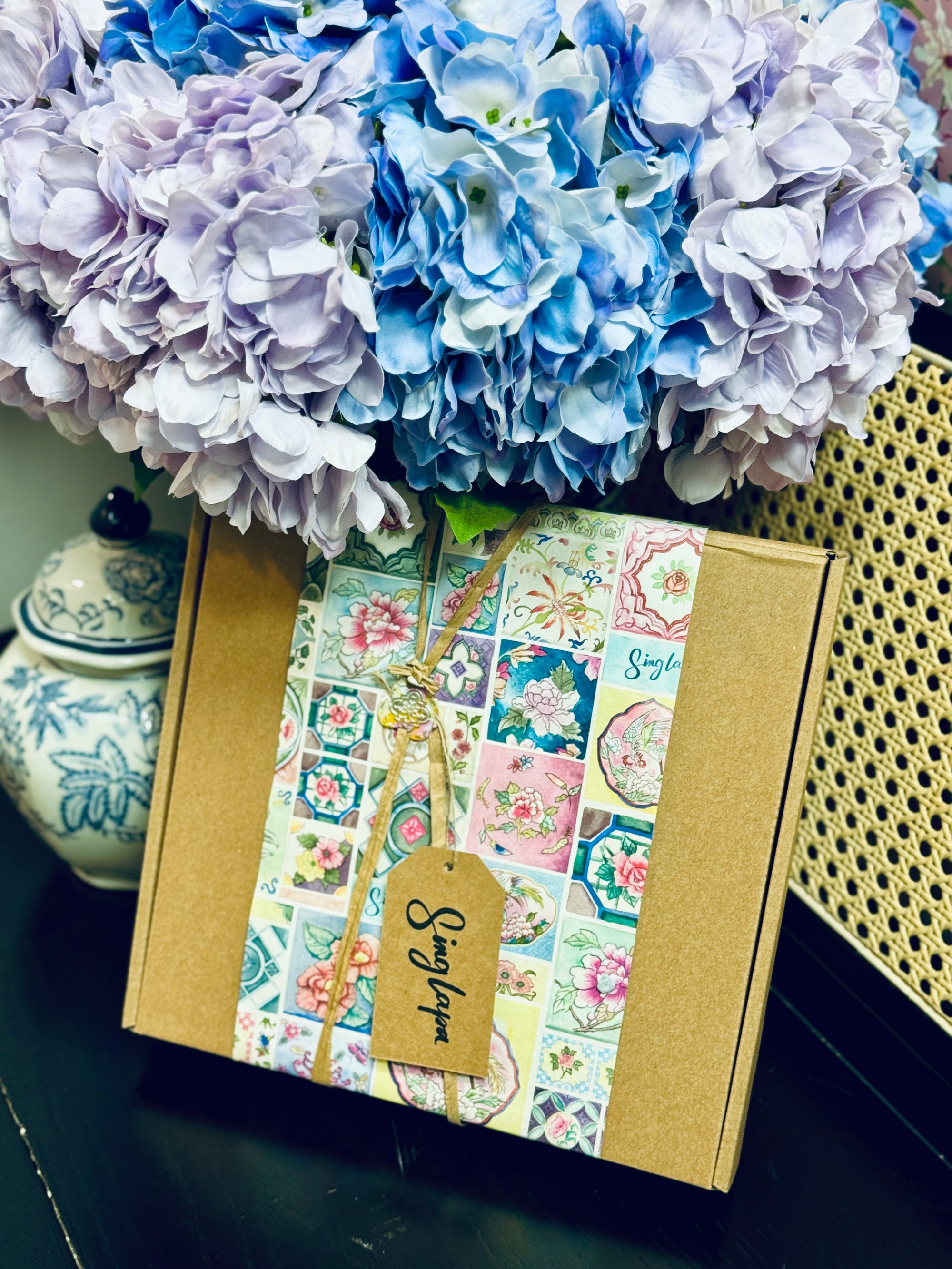 Box with floral paper wrapping and tags with a heat stamp.