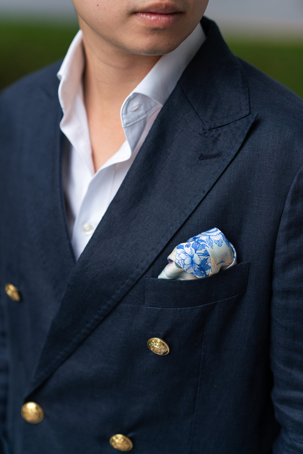 Lifestyle image of man wearing a suit with a grey pocket square