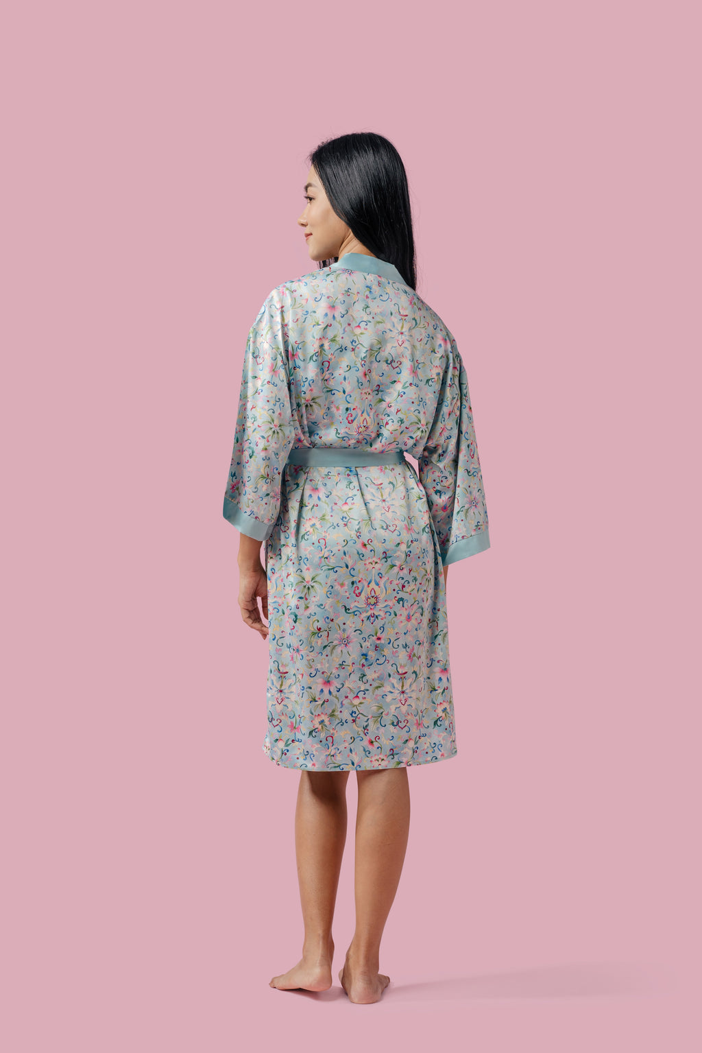 Back view of a woman wearing a silky blue kimono