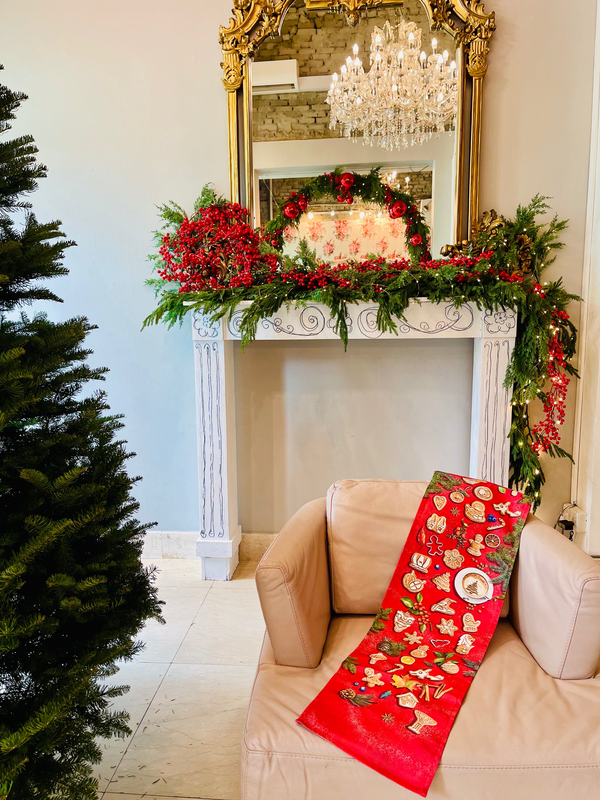 lifestyle image of gingerbread man table runner on a couch and fireplace during christmas