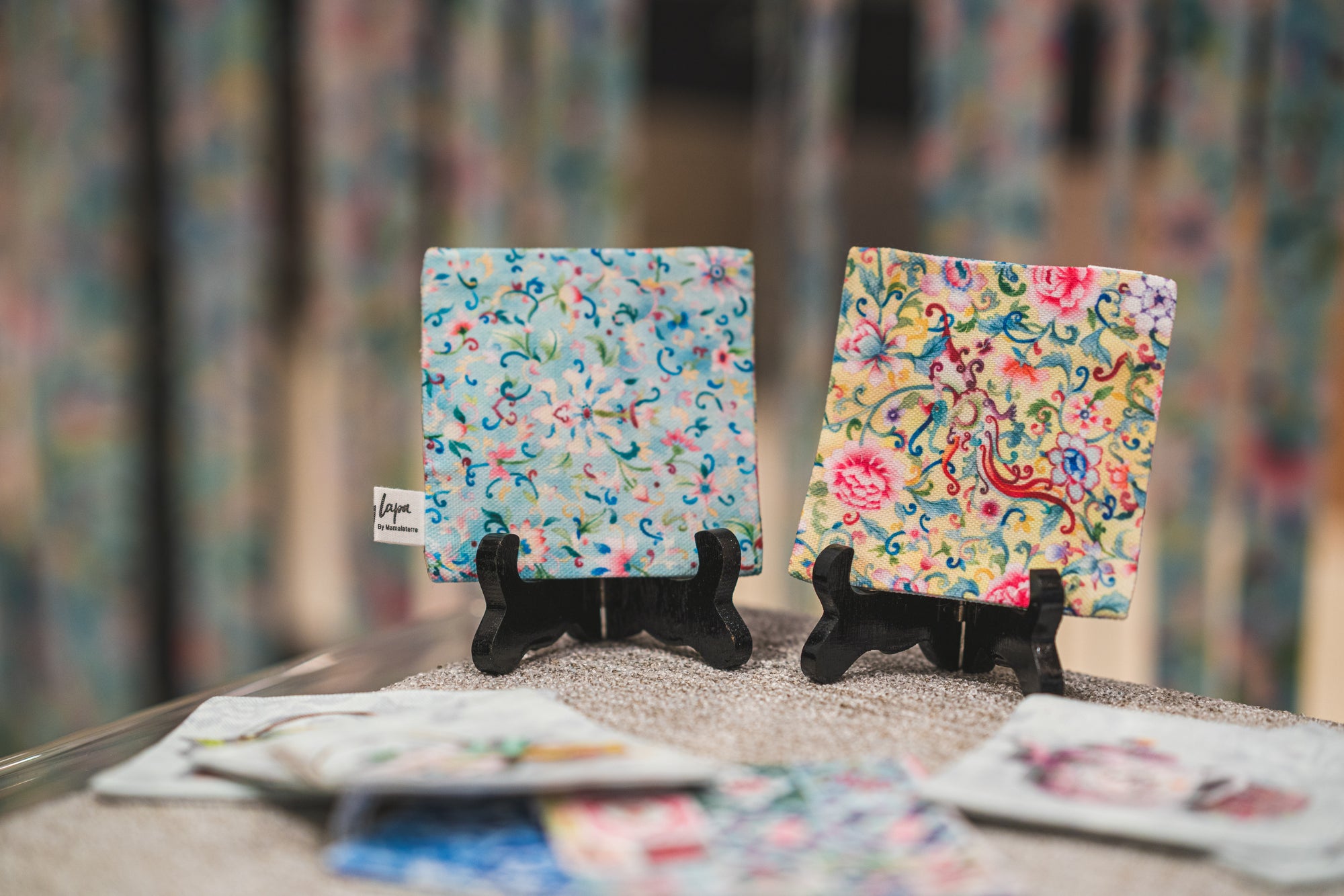 Display of chinese floral coasters from Singlapa, blue and yellow designs.