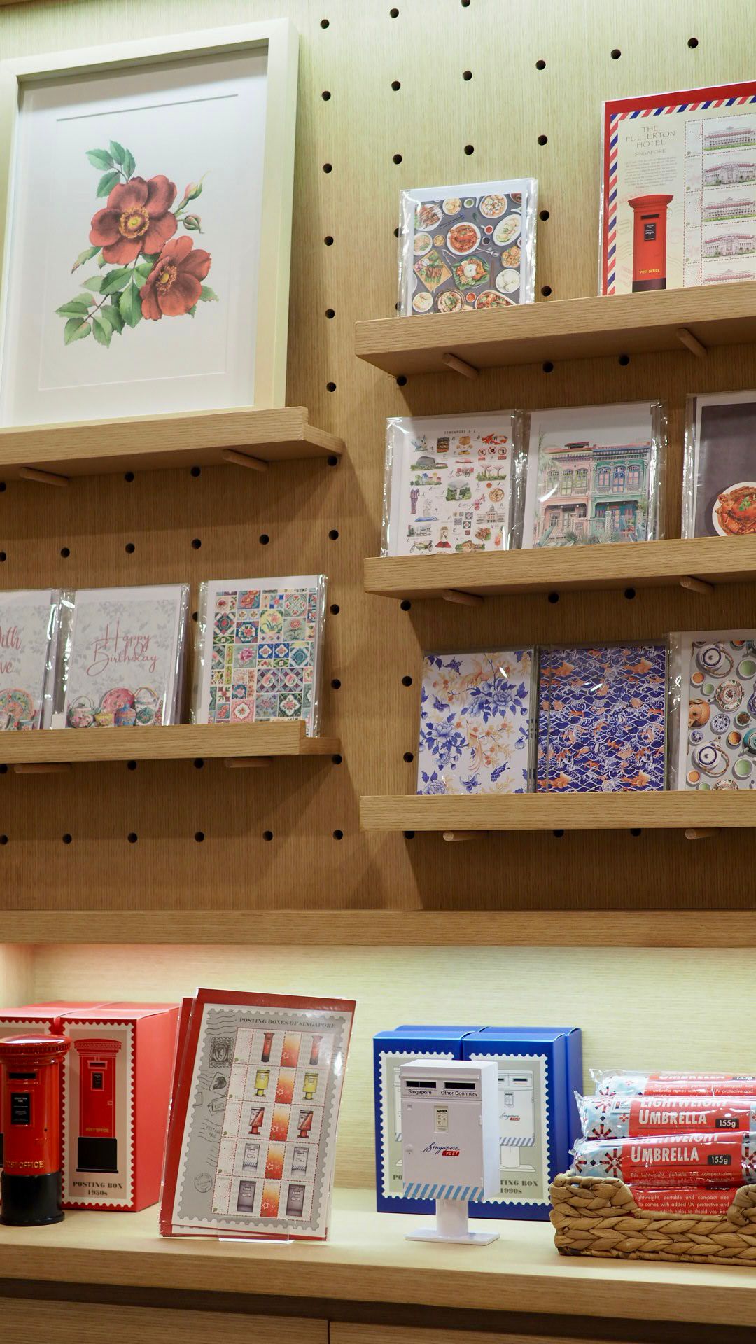 Shelves displaying various greeting cards and stationery items in a store setting.