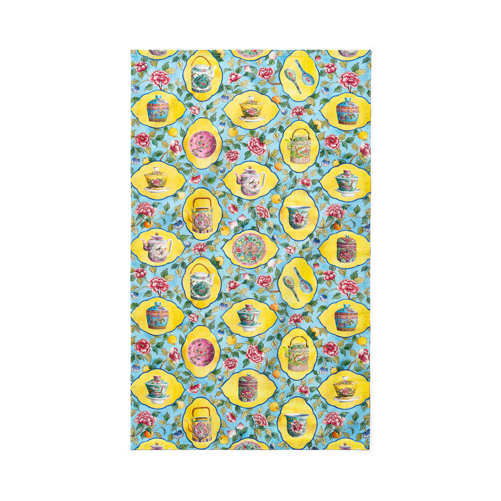 Singlapa tea towel with porcelain in a yellow frame surrounded by flowers on a blue background