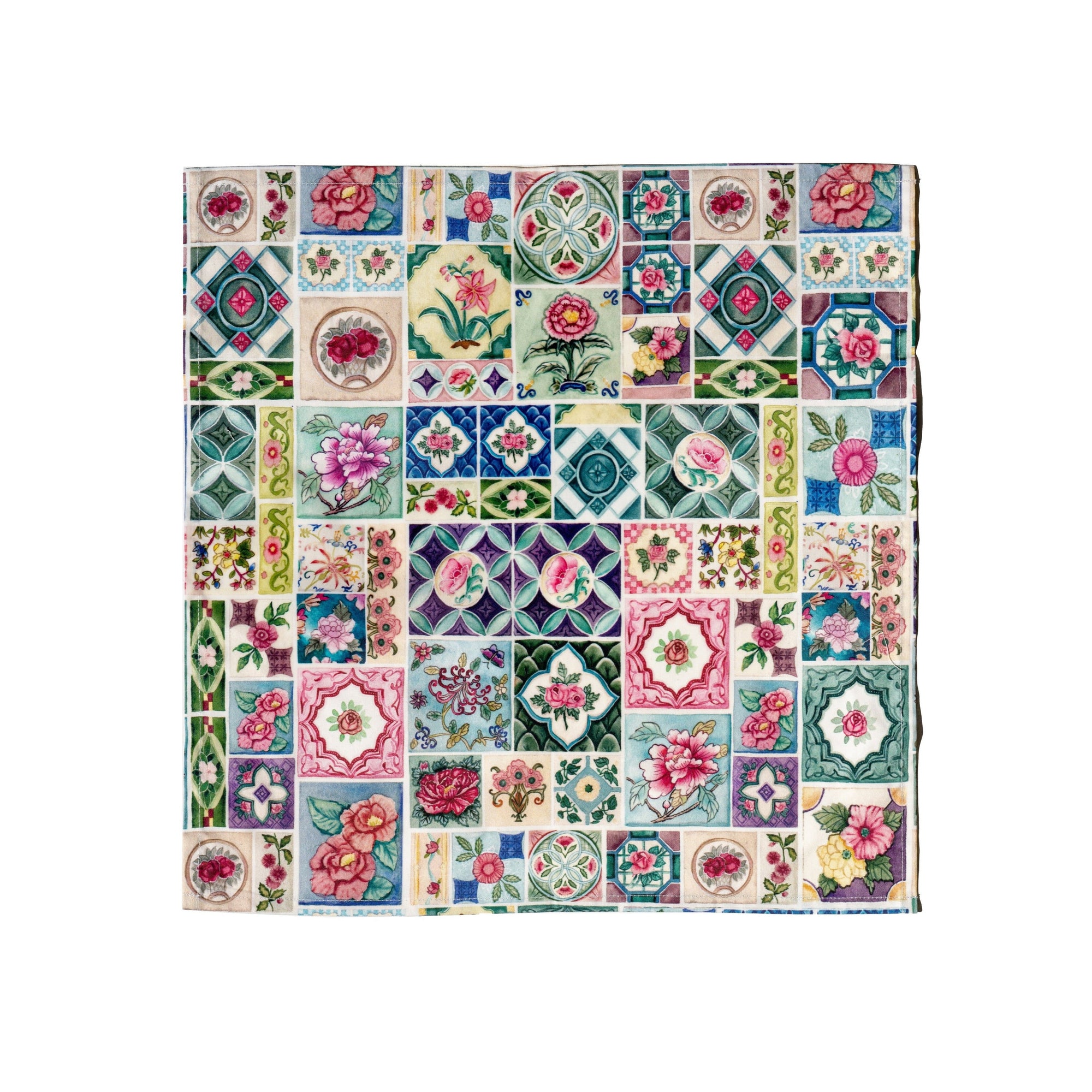 Colorful patchwork quilt with floral and geometric patterns on a white background
