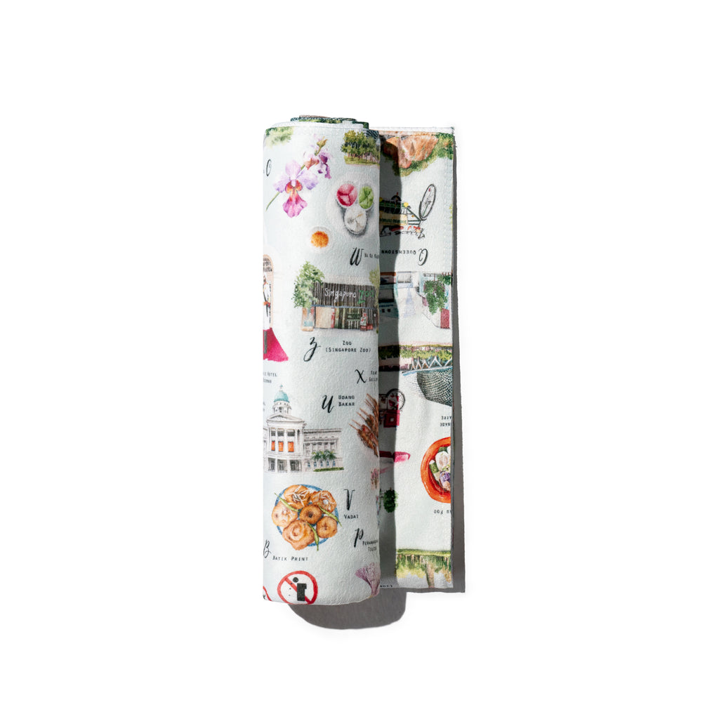Singlapa rolled-up baby towel with various illustrations of singapore icons from A to Z on a white background