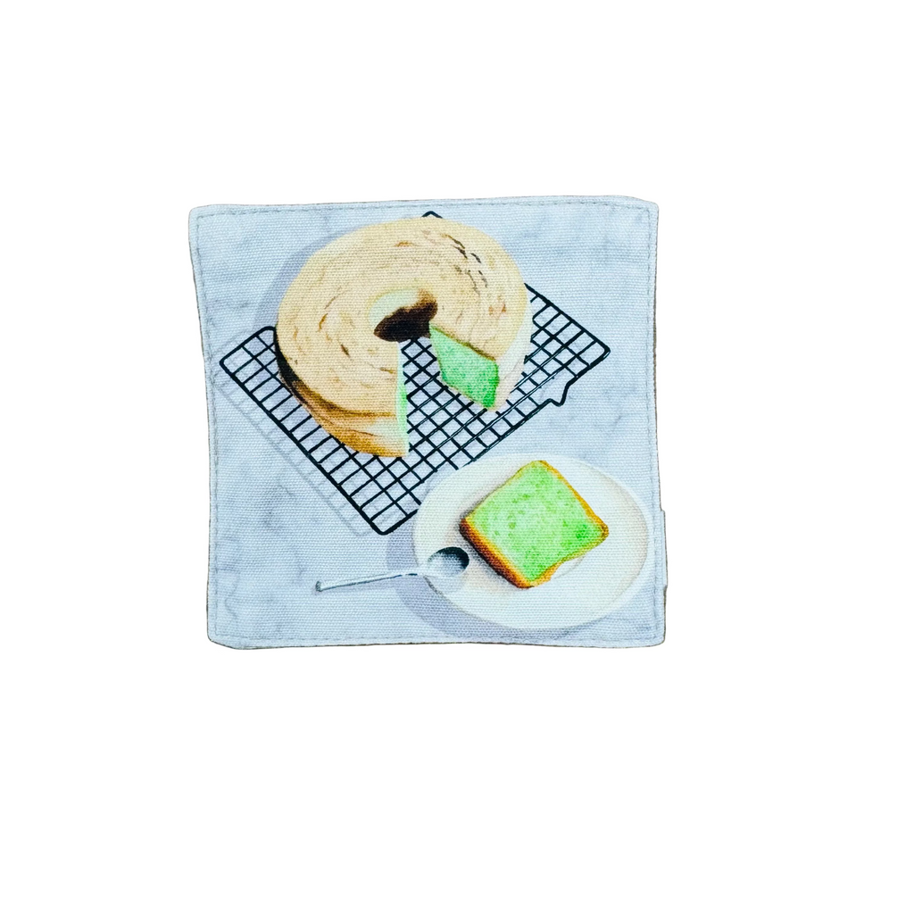 pandan Bread on a cooling rack and plate on a fabric coaster.