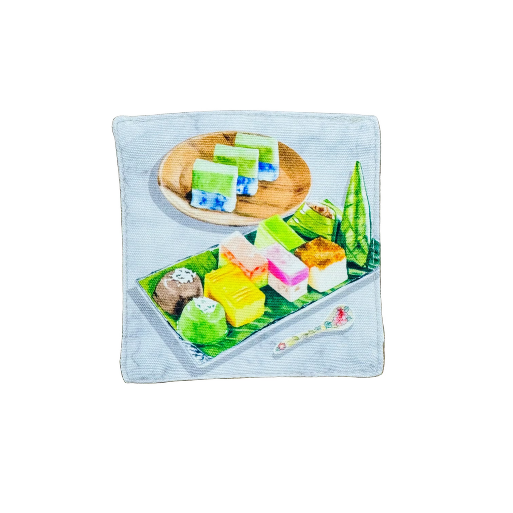 Colorful dessert illustration on a wooden and banana leaf plate on a fabric coaster. 