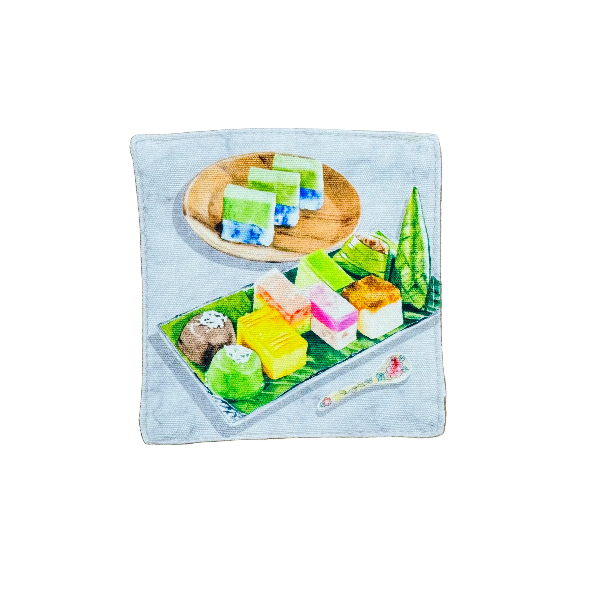 Colorful dessert illustration on a wooden and banana leaf plate on a fabric coaster. 