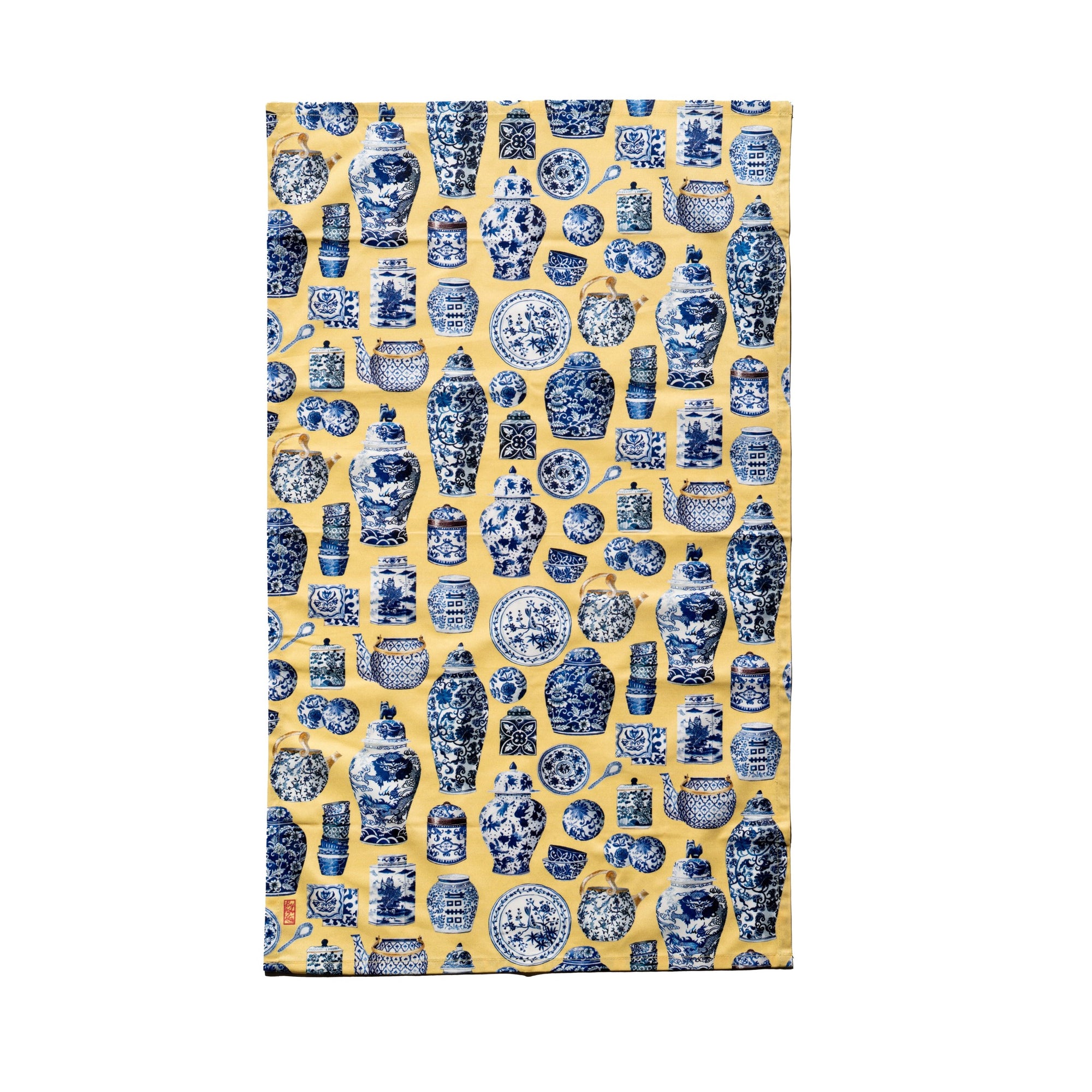 Singlapa yellow tea towel with a blue porcelain floral pattern.